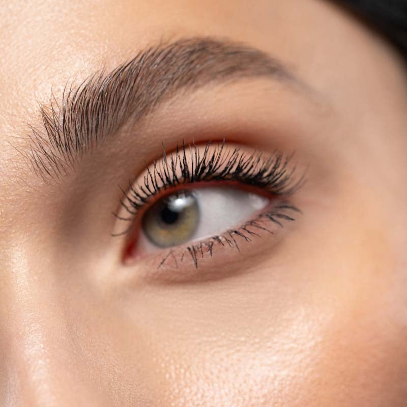Extreme close-up of a woman's eye and eyelashes that she has applied mascara to