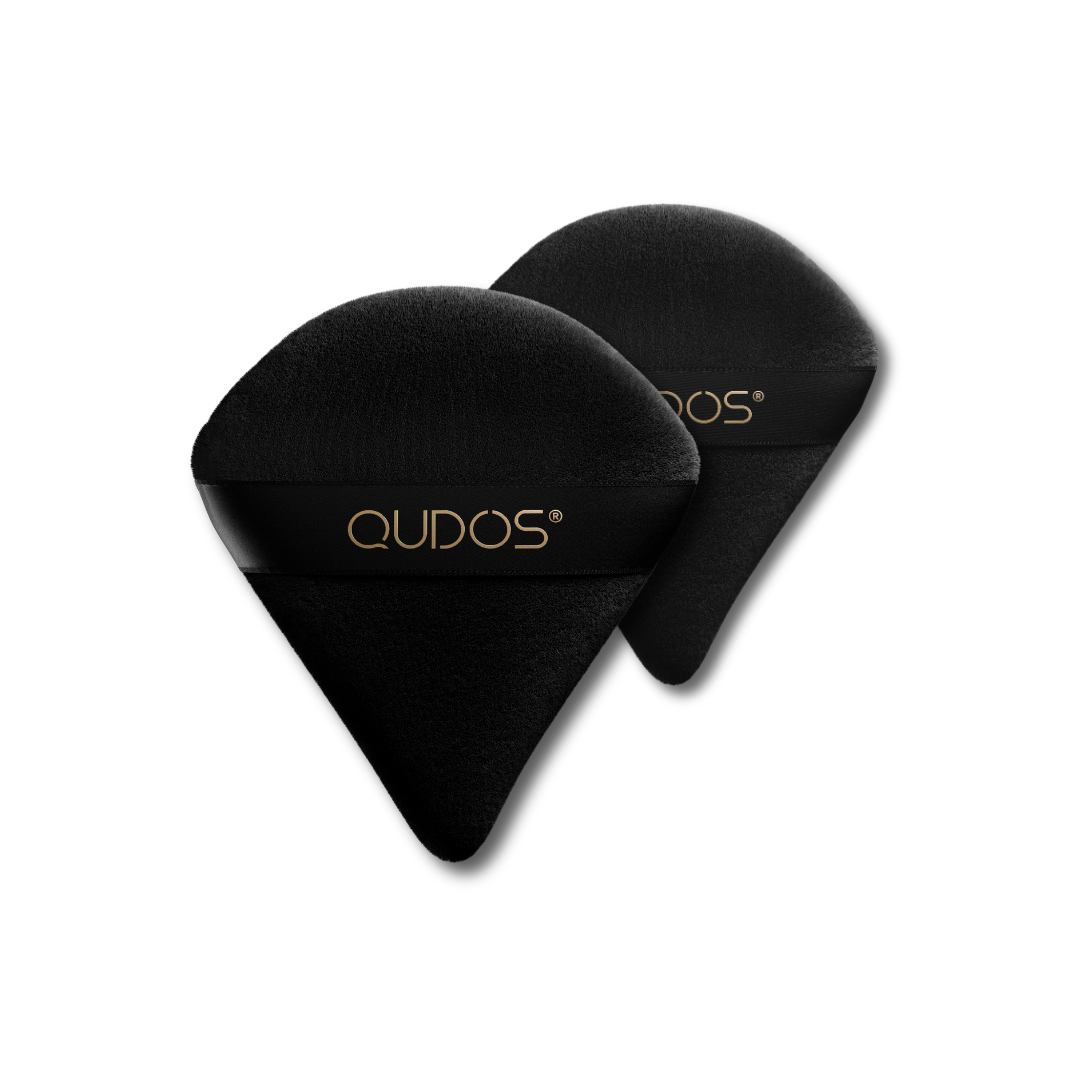 Two Qudos Synergy makeup puffs with a plain background, one placed in front of the other to appear bigger