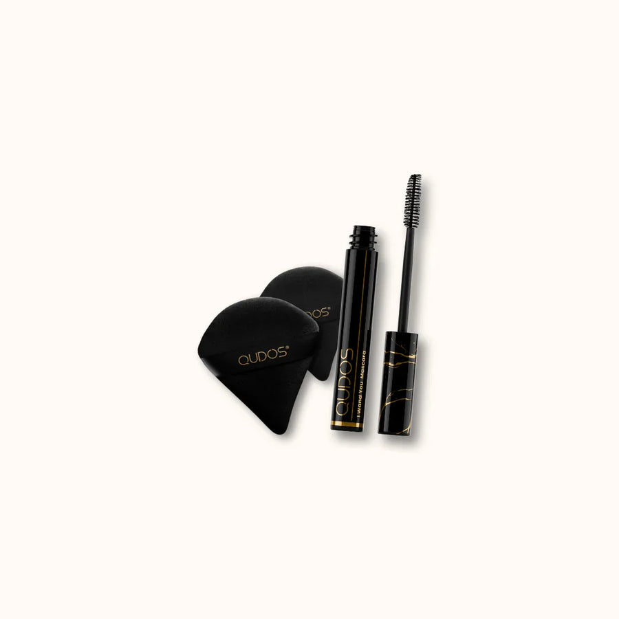Set of Qudos makeup products including I Wand You mascara and applicators on a white background