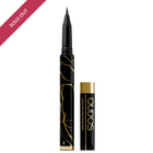 Standing up Qudos eyeliner pen with lid placed on right-hand side 