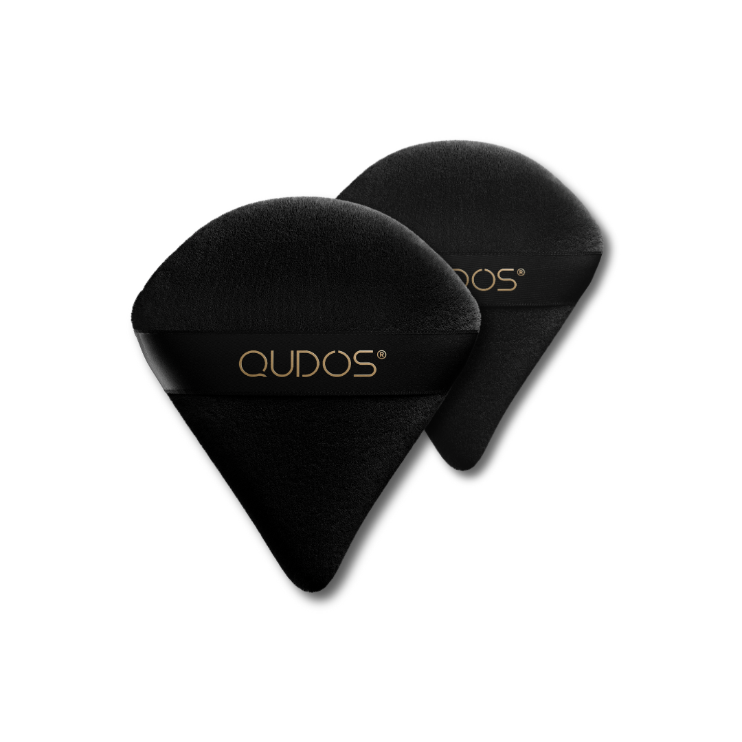 Two Qudos Synergy makeup puffs with a plain background, one placed in front of the other to appear bigger
